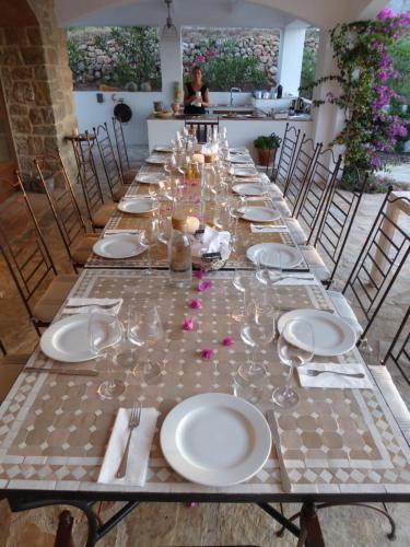 Long outdoor table set for a group dinner at Cuatre Finques