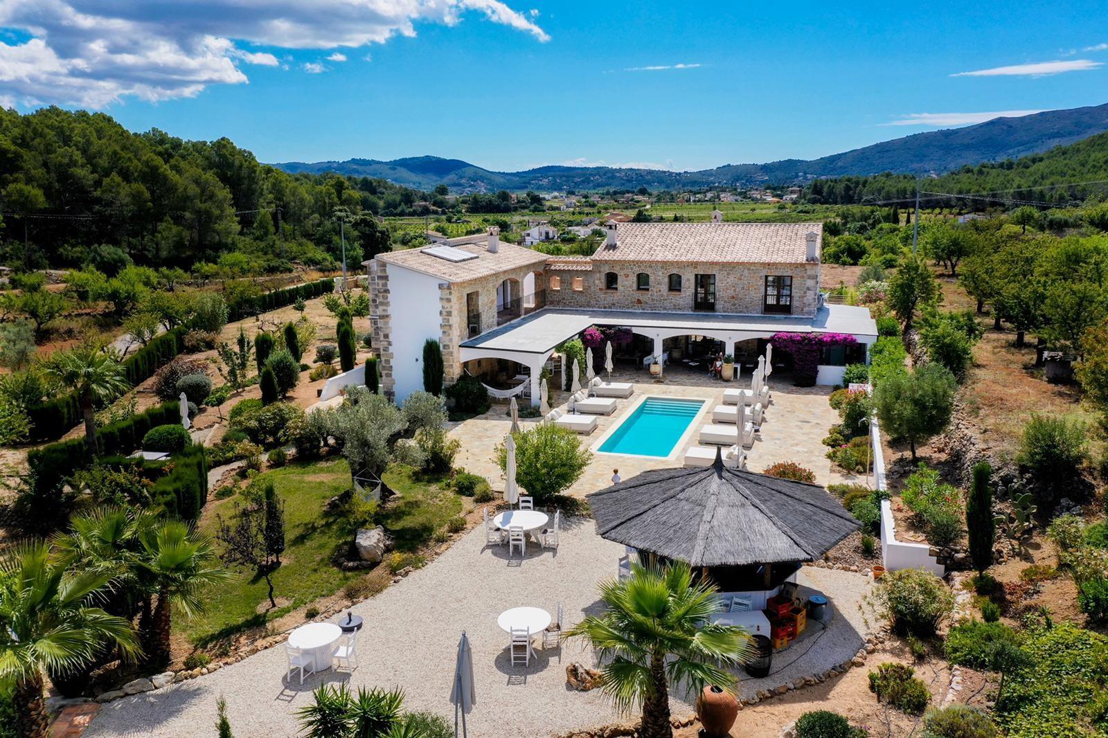 Aerial view of Cuatre Finques finca, pool and gardens surrounded by the Xaló Valley