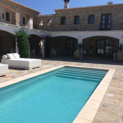 Private pool courtyard with daybeds at Cuatre Finques