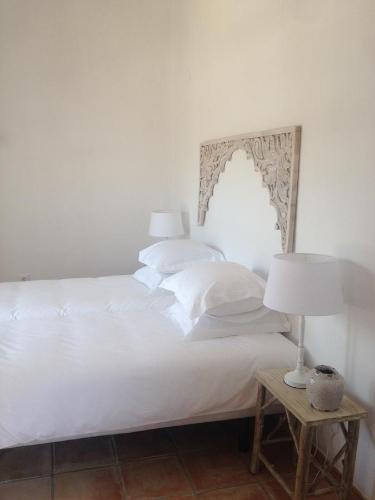 Room with carved wood headboard at Cuatre Finques